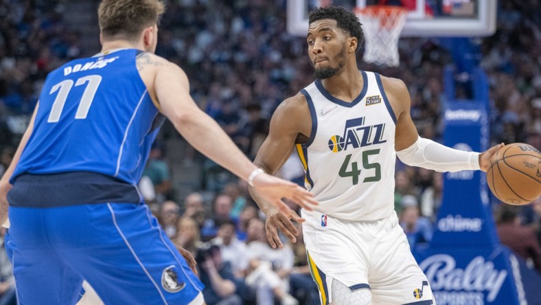 Mar 27, 2022; Dallas, Texas, USA; Dallas Mavericks guard Luka Doncic (77) guards Utah Jazz guard Donovan Mitchell (45) during the game at the American Airlines Center. Mandatory Credit: Jerome Miron-USA TODAY Sports