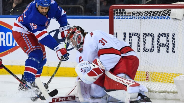 Apr 12, 2022; New York, New York, USA;  Carolina Hurricanes goaltender Frederik Andersen (31) stops the shot by New York Rangers right wing Ryan Reaves (75) during the first period at Madison Square Garden. Mandatory Credit: Dennis Schneidler-USA TODAY Sports