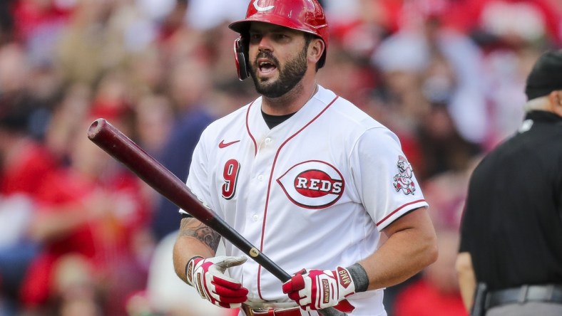 Apr 12, 2022; Cincinnati, Ohio, USA; Cincinnati Reds third baseman Mike Moustakas (9) reacts after striking out against the Cleveland Guardians in the sixth inning at Great American Ball Park. Mandatory Credit: Katie Stratman-USA TODAY Sports