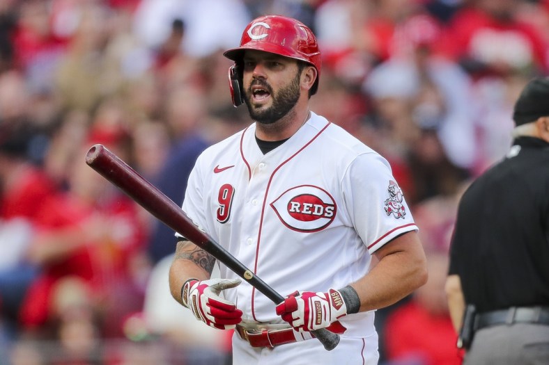 Apr 12, 2022; Cincinnati, Ohio, USA; Cincinnati Reds third baseman Mike Moustakas (9) reacts after striking out against the Cleveland Guardians in the sixth inning at Great American Ball Park. Mandatory Credit: Katie Stratman-USA TODAY Sports