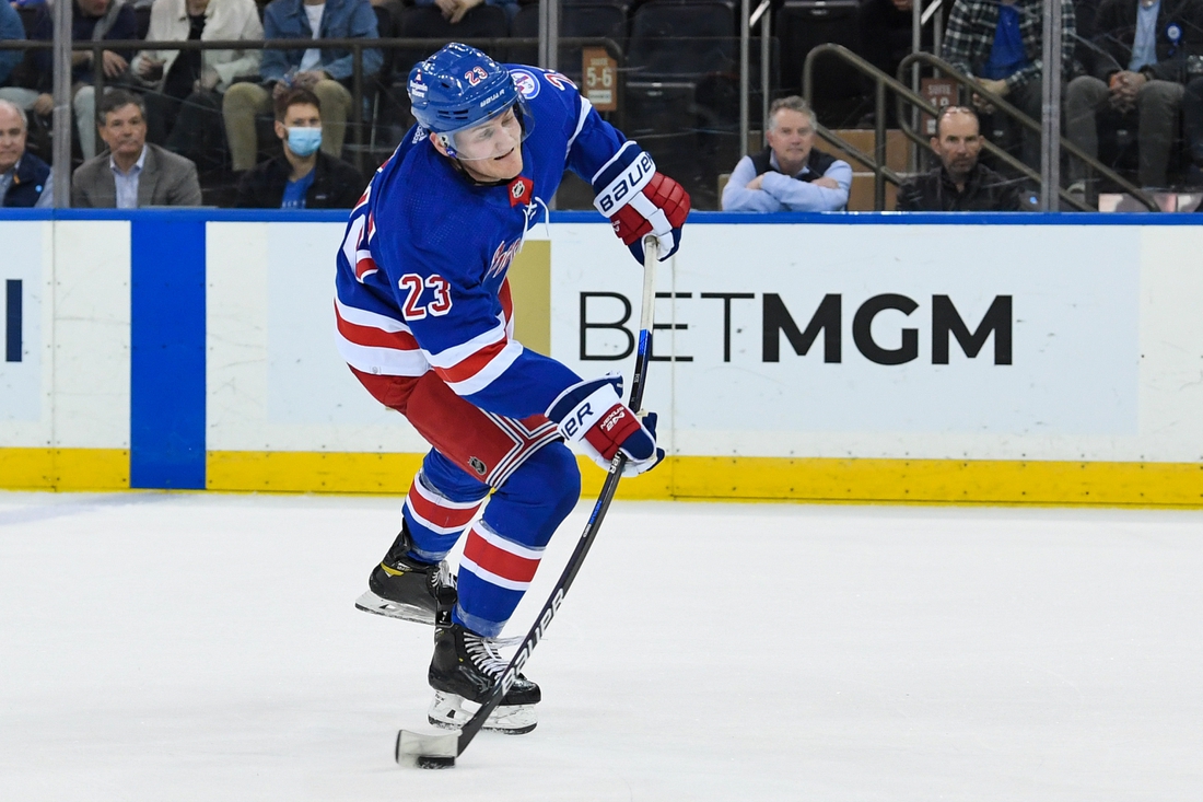 Apr 12, 2022; New York, New York, USA; New York Rangers defenseman Adam Fox (23) attempts a shot against the Carolina Hurricanes during the third period at Madison Square Garden. Mandatory Credit: Dennis Schneidler-USA TODAY Sports