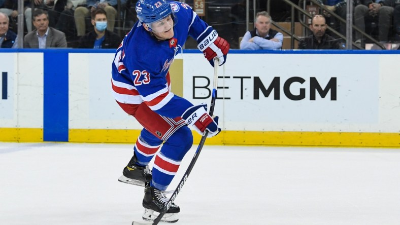 Apr 12, 2022; New York, New York, USA; New York Rangers defenseman Adam Fox (23) attempts a shot against the Carolina Hurricanes during the third period at Madison Square Garden. Mandatory Credit: Dennis Schneidler-USA TODAY Sports