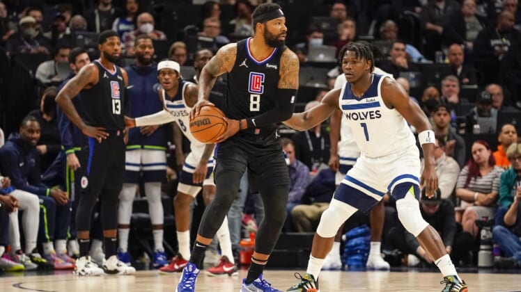 Apr 12, 2022; Minneapolis, Minnesota, USA;  Los Angeles Clippers forward Marcus Morris (8) controls the ball as Minnesota Timberwolves guard Anthony Edwards (1) defends during the first quarter of a play-in game at Target Center. Mandatory Credit: Nick Wosika-USA TODAY Sports