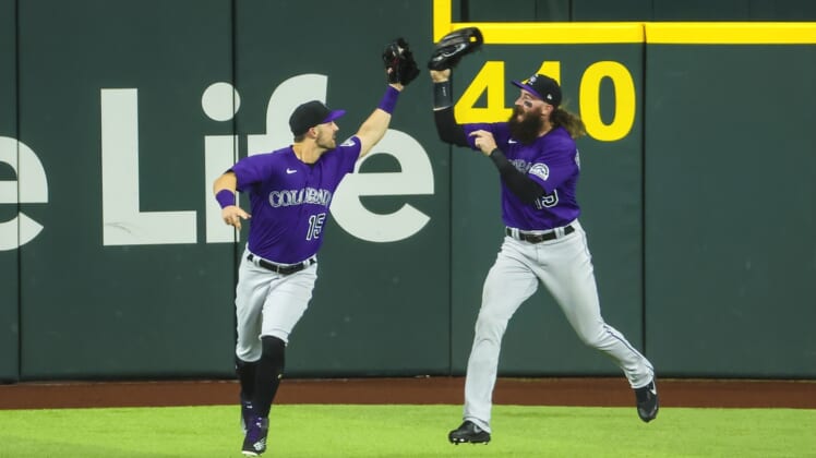 Apr 12, 2022; Arlington, Texas, USA;  Colorado Rockies center fielder Randal Grichuk (15) celebrates with Colorado Rockies right fielder Charlie Blackmon (19) after making a catch during the fifth inning against the Texas Rangers at Globe Life Field. Mandatory Credit: Kevin Jairaj-USA TODAY Sports