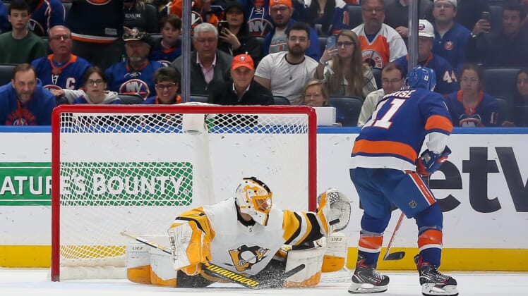 Apr 12, 2022; Elmont, New York, USA; Pittsburgh Penguins goaltender Casey DeSmith (1) makes a save against New York Islanders left wing Zach Parise (11) in the first round of the shootout at UBS Arena. Mandatory Credit: Tom Horak-USA TODAY Sports