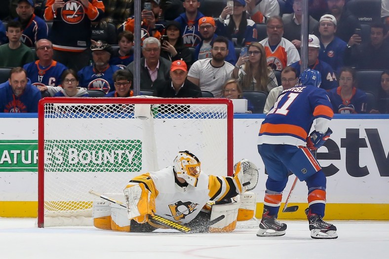 Apr 12, 2022; Elmont, New York, USA; Pittsburgh Penguins goaltender Casey DeSmith (1) makes a save against New York Islanders left wing Zach Parise (11) in the first round of the shootout at UBS Arena. Mandatory Credit: Tom Horak-USA TODAY Sports