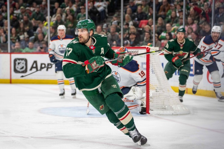 Apr 12, 2022; Saint Paul, Minnesota, USA; Minnesota Wild left wing Marcus Foligno (17) skates after a loose puck in the Edmonton Oilers end in the second period at Xcel Energy Center. Mandatory Credit: Matt Blewett-USA TODAY Sports