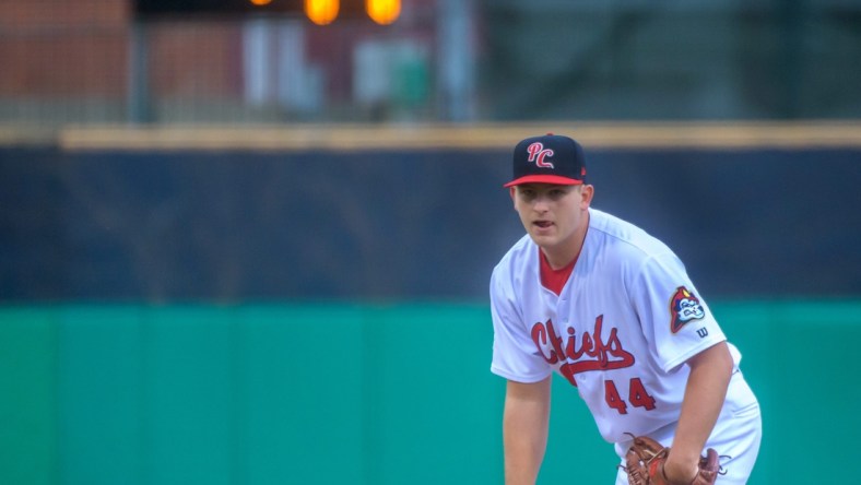 A pitch clock runs in the background as Peoria Chiefs pitcher Austin Love prepares to throw against the Great Lakes Loons in the Chiefs' home opener Tuesday, April 12, 2022 at Dozer Park in Peoria.