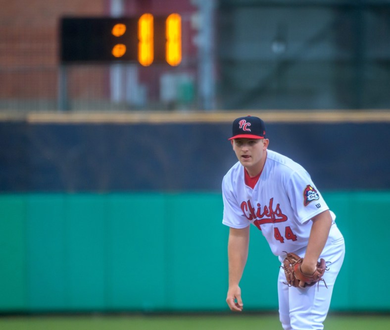 A pitch clock runs in the background as Peoria Chiefs pitcher Austin Love prepares to throw against the Great Lakes Loons in the Chiefs' home opener Tuesday, April 12, 2022 at Dozer Park in Peoria.