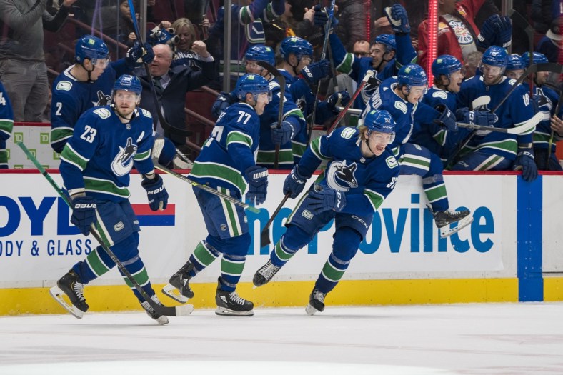 Apr 12, 2022; Vancouver, British Columbia, CAN; The Vancouver Canucks bench celebrates the game winning goal scored by defenseman Quinn Hughes (43) against the Vegas Golden Knights in the third period at Rogers Arena. Canucks won 5-4 in overtime. Mandatory Credit: Bob Frid-USA TODAY Sports