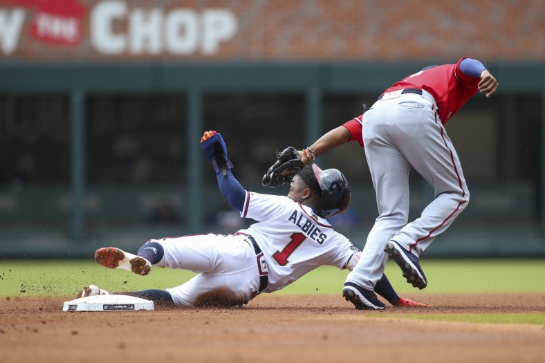Apr 13, 2022; Atlanta, Georgia, USA; Atlanta Braves second baseman Ozzie Albies (1) is tagged out on a steal attempt by Washington Nationals shortstop Alcides Escobar (3) in the first inning at Truist Park. Mandatory Credit: Brett Davis-USA TODAY Sports