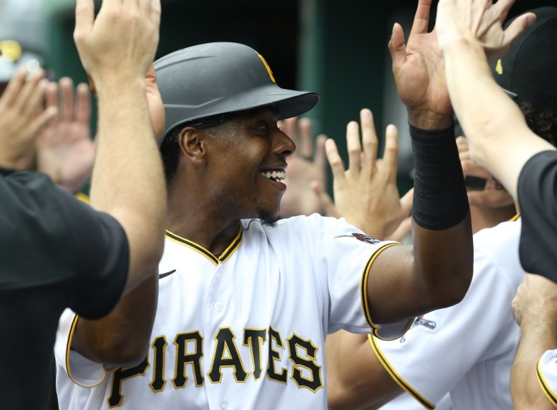 Apr 13, 2022; Pittsburgh, Pennsylvania, USA;  Pittsburgh Pirates third baseman Ke'Bryan Hayes (13) high-fives in the dugout after scoring a run against the Chicago Cubs during the third inning at PNC Park. Mandatory Credit: Charles LeClaire-USA TODAY Sports