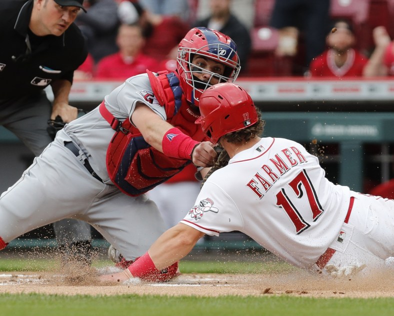 Apr 13, 2022; Cincinnati, Ohio, USA; Cincinnati Reds shortstop Kyle Farmer (right) is tagged out at home by Cleveland Guardians catcher Austin Hedges (left) during the second inning at Great American Ball Park. Mandatory Credit: David Kohl-USA TODAY Sports