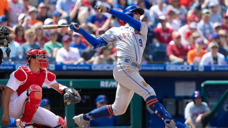 Apr 13, 2022; Philadelphia, Pennsylvania, USA; New York Mets center fielder Brandon Nimmo (9) hits a home run in front of Philadelphia Phillies catcher J.T. Realmuto (10) during the third inning at Citizens Bank Park. Mandatory Credit: Bill Streicher-USA TODAY Sports