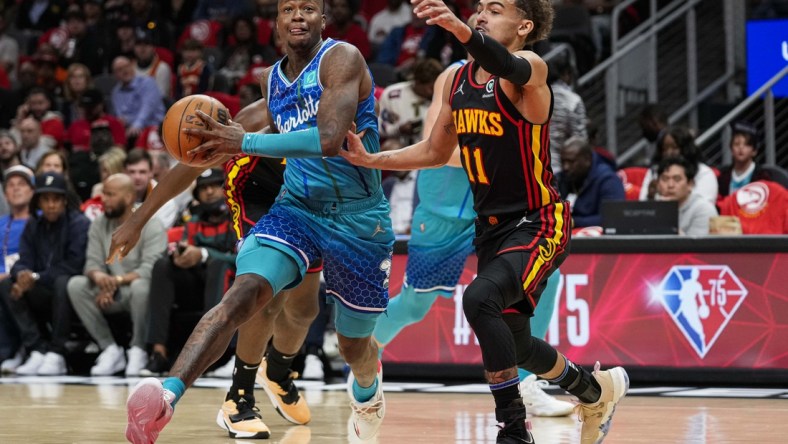 Apr 13, 2022; Atlanta, Georgia, USA; Charlotte Hornets guard Terry Rozier (3) drives to the basket against Atlanta Hawks guard Trae Young (11) during the first half at State Farm Arena. Mandatory Credit: Dale Zanine-USA TODAY Sports