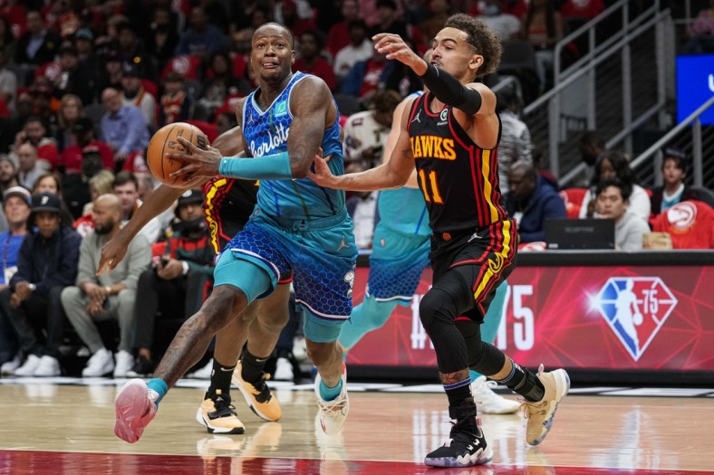 Apr 13, 2022; Atlanta, Georgia, USA; Charlotte Hornets guard Terry Rozier (3) drives to the basket against Atlanta Hawks guard Trae Young (11) during the first half at State Farm Arena. Mandatory Credit: Dale Zanine-USA TODAY Sports