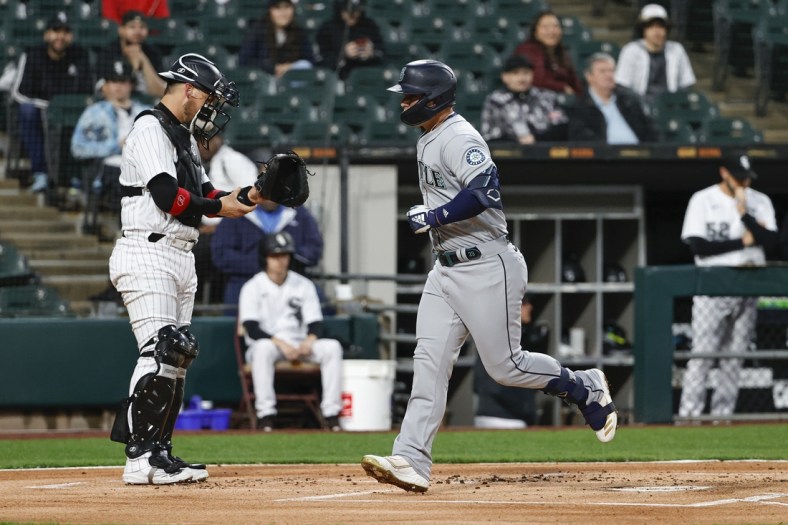 Apr 13, 2022; Chicago, Illinois, USA; Seattle Mariners third baseman Ty France (23) crosses home plate after hitting a solo home run against the Chicago White Sox during the first inning at Guaranteed Rate Field. Mandatory Credit: Kamil Krzaczynski-USA TODAY Sports