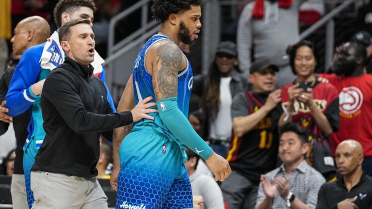Apr 13, 2022; Atlanta, Georgia, USA; Charlotte Hornets forward Miles Bridges (0) is restrained after being called for a technical foul and being ejected from the game against the Atlanta Hawks during the second half at State Farm Arena. Mandatory Credit: Dale Zanine-USA TODAY Sports