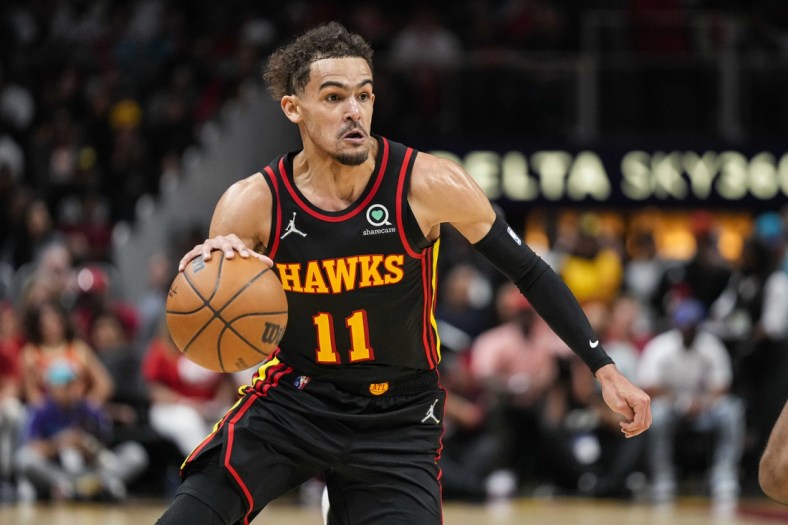 Apr 13, 2022; Atlanta, Georgia, USA; Atlanta Hawks guard Trae Young (11) controls the ball against the Charlotte Hornets during the second half at State Farm Arena. Mandatory Credit: Dale Zanine-USA TODAY Sports