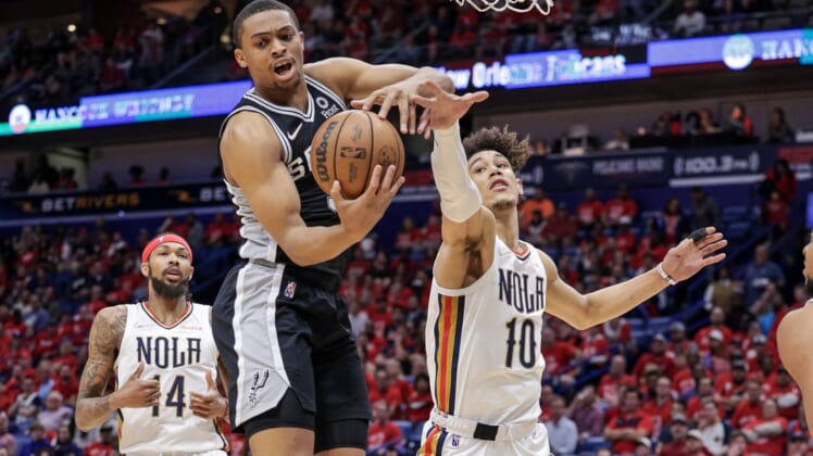 Apr 13, 2022; New Orleans, Louisiana, USA; San Antonio Spurs forward Keldon Johnson (3) grabs a rebound against New Orleans Pelicans center Jaxson Hayes (10) during the first half of a play-in playoff game at the Smoothie King Center. Mandatory Credit: Stephen Lew-USA TODAY Sports