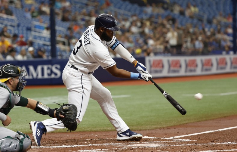 Apr 14, 2022; St. Petersburg, Florida, USA;  Tampa Bay Rays right fielder Manuel Margot (13) hits a RBI single during the second inning against the Oakland Athletics at Tropicana Field. Mandatory Credit: Kim Klement-USA TODAY Sports