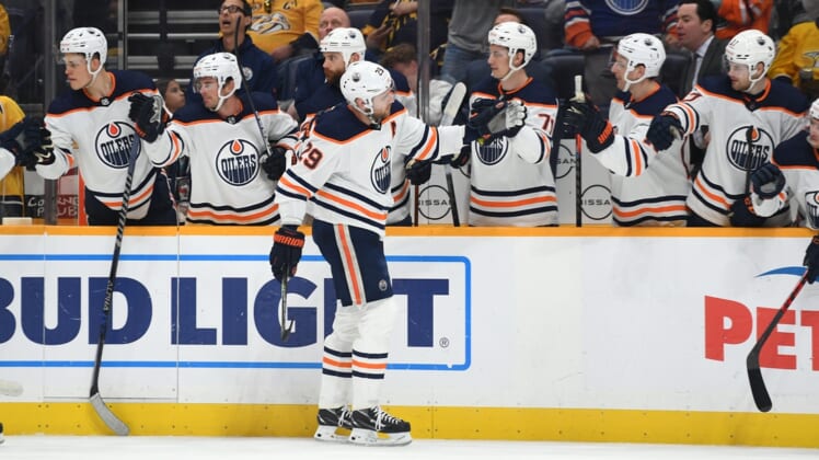 Apr 14, 2022; Nashville, Tennessee, USA;  Edmonton Oilers center Leon Draisaitl (29) is congratulated by teammates after a goal during the first period against the Nashville Predators at Bridgestone Arena. Mandatory Credit: Christopher Hanewinckel-USA TODAY Sports