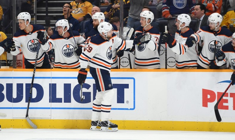 Apr 14, 2022; Nashville, Tennessee, USA;  Edmonton Oilers center Leon Draisaitl (29) is congratulated by teammates after a goal during the first period against the Nashville Predators at Bridgestone Arena. Mandatory Credit: Christopher Hanewinckel-USA TODAY Sports