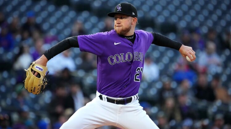 Apr 14, 2022; Denver, Colorado, USA; Colorado Rockies starting pitcher Kyle Freeland (21) delivers a pitch in the first inning against the Chicago Cubs at Coors Field. Mandatory Credit: Ron Chenoy-USA TODAY Sports
