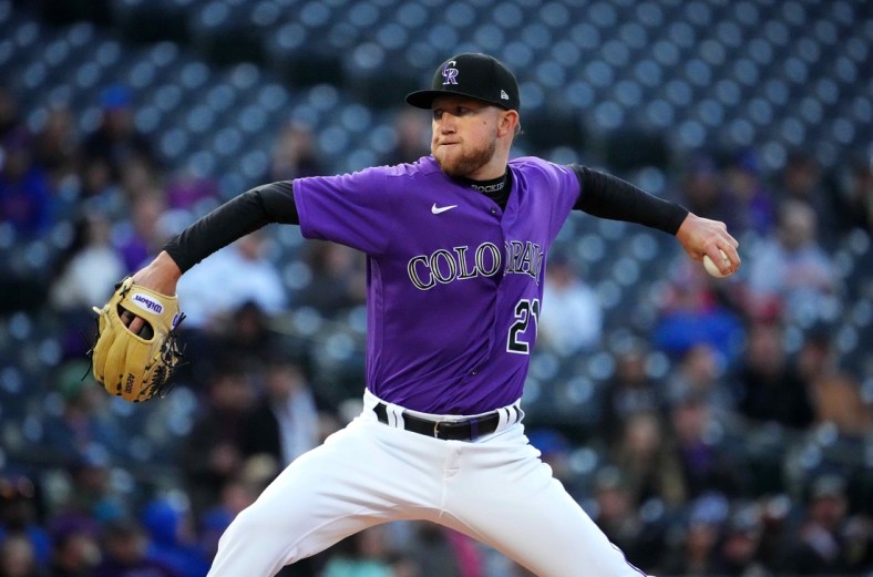 Apr 14, 2022; Denver, Colorado, USA; Colorado Rockies starting pitcher Kyle Freeland (21) delivers a pitch in the first inning against the Chicago Cubs at Coors Field. Mandatory Credit: Ron Chenoy-USA TODAY Sports
