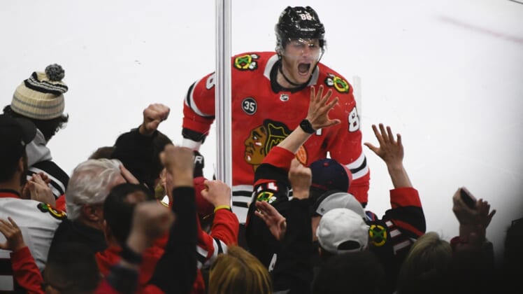 Apr 14, 2022; Chicago, Illinois, USA; Chicago Blackhawks right wing Patrick Kane (88) celebrates after he  scores a goal against San Jose Sharks goaltender James Reimer (47) during the first period at the United Center. Mandatory Credit: Matt Marton-USA TODAY Sports