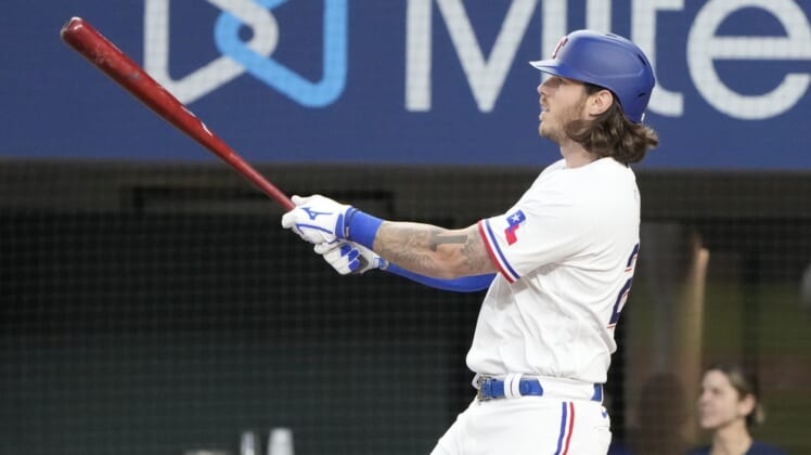 Apr 14, 2022; Arlington, Texas, USA; Texas Rangers catcher Jonah Heim (28) follows thorough on his grand slam home run against the Los Angeles Angels during the fourth inning of a baseball game at Globe Life Field. Mandatory Credit: Jim Cowsert-USA TODAY Sports
