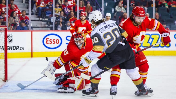 Apr 14, 2022; Calgary, Alberta, CAN; Calgary Flames goaltender Jacob Markstrom (25) makes a save against Vegas Golden Knights center Chandler Stephenson (20) during the first period at Scotiabank Saddledome. Mandatory Credit: Sergei Belski-USA TODAY Sports