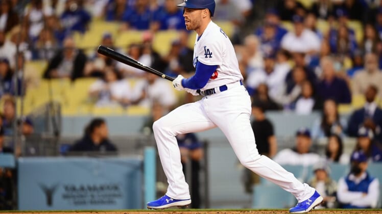 Apr 14, 2022; Los Angeles, California, USA; Los Angeles Dodgers first baseman Freddie Freeman (5) hits a single against the Cincinnati Reds during the first inning at Dodger Stadium. Mandatory Credit: Gary A. Vasquez-USA TODAY Sports