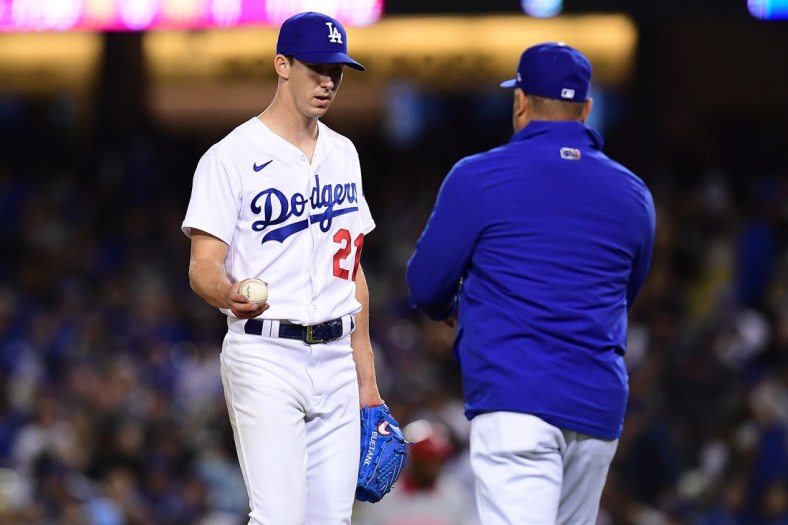 Apr 14, 2022; Los Angeles, California, USA; Los Angeles Dodgers starting pitcher Walker Buehler (21) is relieved by manager Dave Roberts (30) against the Cincinnati Reds during the sixth inning  at Dodger Stadium. Mandatory Credit: Gary A. Vasquez-USA TODAY Sports