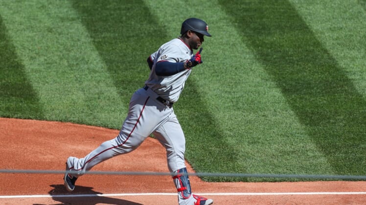 Apr 15, 2022; Boston, Massachusetts, USA; Minnesota Twins first baseman Miguel Sano (22) reacts after hitting a home run during the second inning against the Boston Red Sox at Fenway Park. Every player is wearing number 42 in honor of Jackie Robinson. Mandatory Credit: Paul Rutherford-USA TODAY Sports