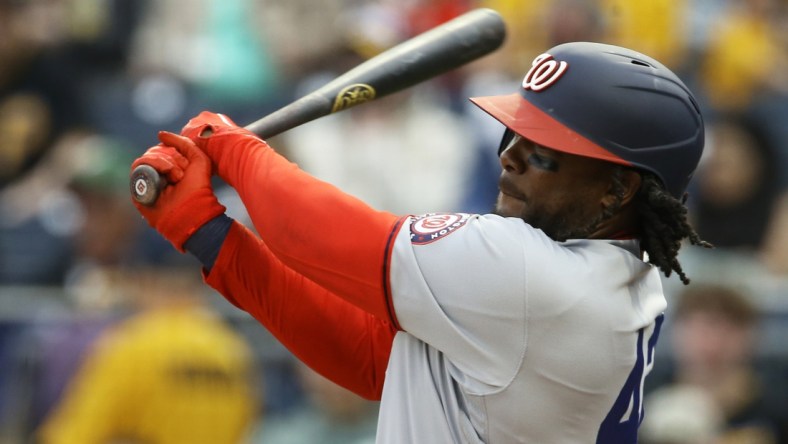 Apr 15, 2022; Pittsburgh, Pennsylvania, USA;  Washington Nationals first baseman Josh Bell (19) hits an RBI single against the Pittsburgh Pirates during the first inning at PNC Park. Mandatory Credit: Charles LeClaire-USA TODAY Sports