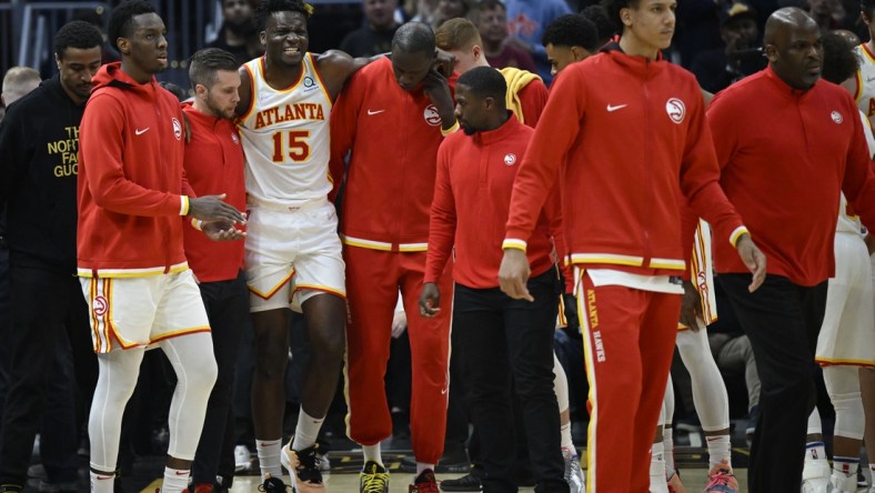 Apr 15, 2022; Cleveland, Ohio, USA; Atlanta Hawks center Clint Capela (15) is helped off the court in the second quarter against the Cleveland Cavaliers at Rocket Mortgage FieldHouse. Mandatory Credit: David Richard-USA TODAY Sports