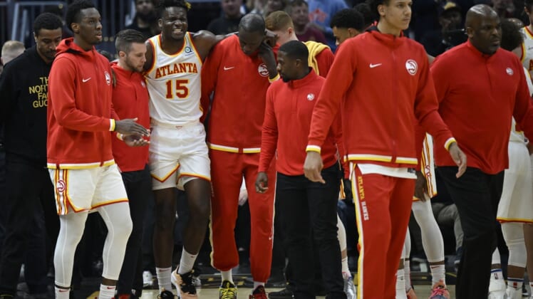 Apr 15, 2022; Cleveland, Ohio, USA; Atlanta Hawks center Clint Capela (15) is helped off the court in the second quarter against the Cleveland Cavaliers at Rocket Mortgage FieldHouse. Mandatory Credit: David Richard-USA TODAY Sports
