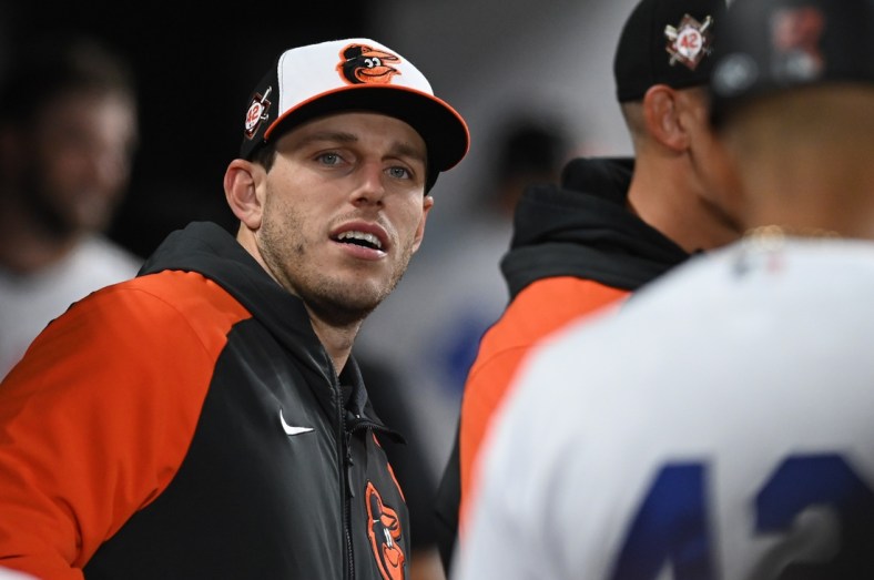 Apr 15, 2022; Baltimore, Maryland, USA;  Baltimore Orioles starting pitcher John Means stands in the dugout during the game against the New York Yankees at Oriole Park at Camden Yards.  Means was put on the IL today. Mandatory Credit: Tommy Gilligan-USA TODAY Sports