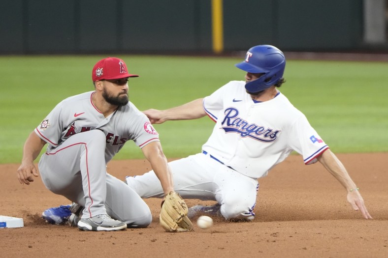 Apr 15, 2022; Arlington, Texas, USA; Texas Rangers designated hitter Nick Solak (right) steals second base ahead of the throw to Los Angeles Angels second baseman Jack Mayfield (left) during the second inning of a baseball game at Globe Life Field. Mandatory Credit: Jim Cowsert-USA TODAY Sports
