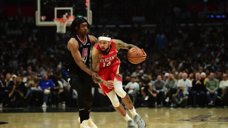 Apr 15, 2022; Los Angeles, California, USA; New Orleans Pelicans forward Brandon Ingram (14) moves the ball against Los Angeles Clippers guard Terance Mann (14) during the first half of the play in game at Crypto.com Arena. Mandatory Credit: Gary A. Vasquez-USA TODAY Sports
