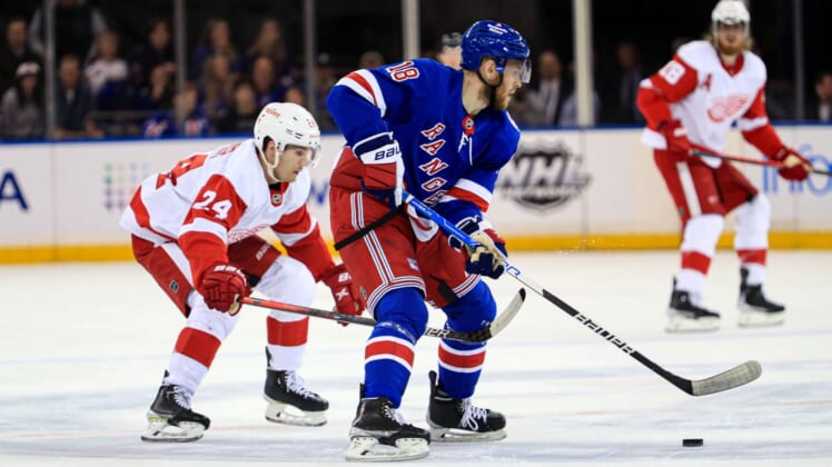 Apr 16, 2022; New York, New York, USA; New York Rangers center Andrew Copp (18) skates ahead of Detroit Red Wings center Pius Suter (24) during the first period at Madison Square Garden. Mandatory Credit: Danny Wild-USA TODAY Sports