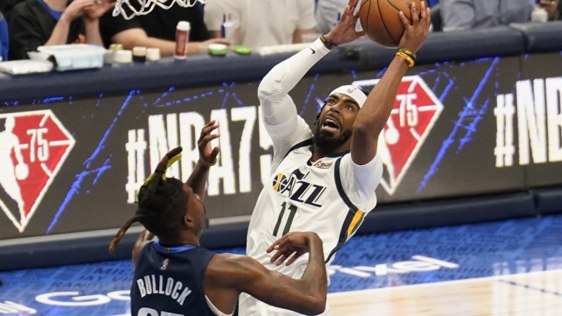 Apr 16, 2022; Dallas, Texas, USA; Utah Jazz guard Mike Conley (11) shoots over Dallas Mavericks forward Reggie Bullock (25) in the first half of game one of the first round for the 2022 NBA playoffs at American Airlines Center. Mandatory Credit: Scott Wachter-USA TODAY Sports