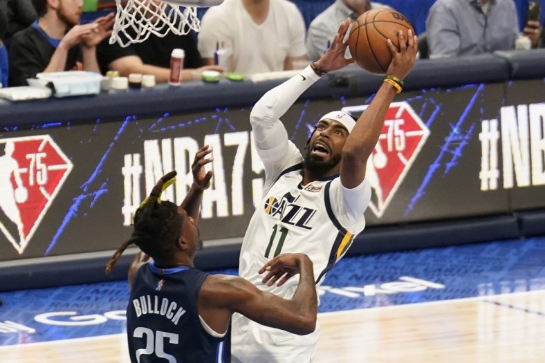 Apr 16, 2022; Dallas, Texas, USA; Utah Jazz guard Mike Conley (11) shoots over Dallas Mavericks forward Reggie Bullock (25) in the first half of game one of the first round for the 2022 NBA playoffs at American Airlines Center. Mandatory Credit: Scott Wachter-USA TODAY Sports