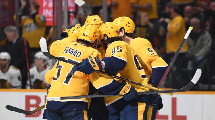 Apr 16, 2022; Nashville, Tennessee, USA; Nashville Predators players celebrate after a goal by center Mikael Granlund (64) during the third period against the Chicago Blackhawks at Bridgestone Arena. Mandatory Credit: Christopher Hanewinckel-USA TODAY Sports