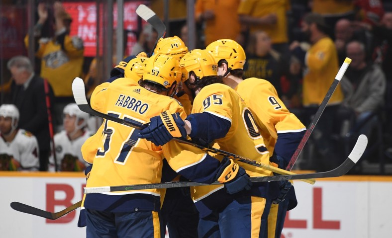 Apr 16, 2022; Nashville, Tennessee, USA; Nashville Predators players celebrate after a goal by center Mikael Granlund (64) during the third period against the Chicago Blackhawks at Bridgestone Arena. Mandatory Credit: Christopher Hanewinckel-USA TODAY Sports