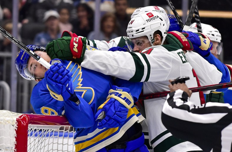 Apr 16, 2022; St. Louis, Missouri, USA;  St. Louis Blues center Ivan Barbashev (49) is pushed in to the net by Minnesota Wild center Joel Eriksson Ek (14) during the second period at Enterprise Center. Mandatory Credit: Jeff Curry-USA TODAY Sports