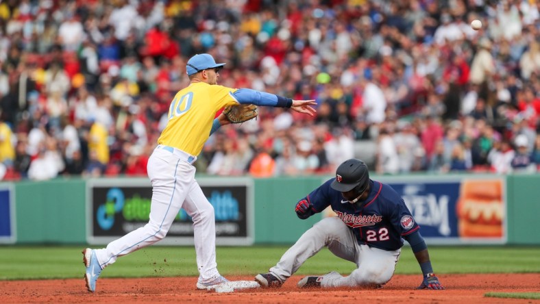 Apr 16, 2022; Boston, Massachusetts, USA; Boston Red Sox second baseman Trevor Story (10) throws over Minnesota Twins first baseman Miguel Sano (22) during the third inning at Fenway Park. Mandatory Credit: Paul Rutherford-USA TODAY Sports