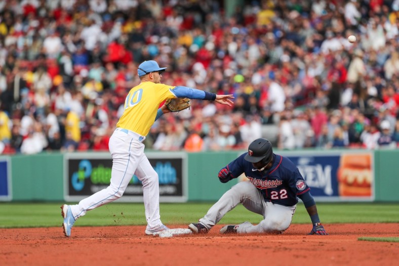Apr 16, 2022; Boston, Massachusetts, USA; Boston Red Sox second baseman Trevor Story (10) throws over Minnesota Twins first baseman Miguel Sano (22) during the third inning at Fenway Park. Mandatory Credit: Paul Rutherford-USA TODAY Sports