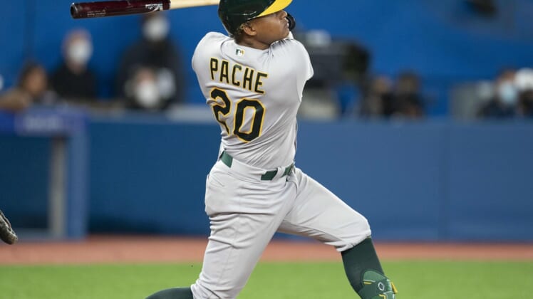 Apr 16, 2022; Toronto, Ontario, CAN; Oakland Athletics center fielder Cristian Pache (20) hits a two run home run during the ninth inning against the Toronto Blue Jays at Rogers Centre. Mandatory Credit: Nick Turchiaro-USA TODAY Sports
